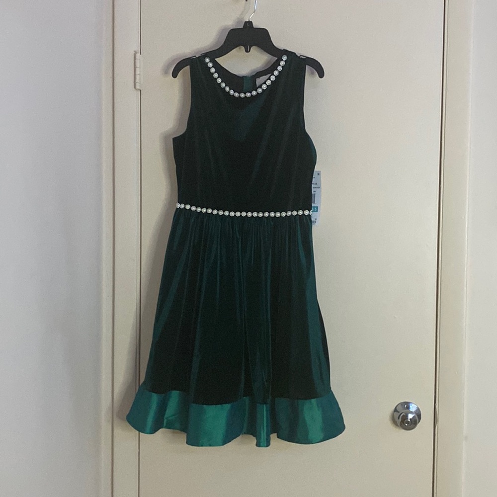 A dark green dress with pearl decorations at the top and waist line,